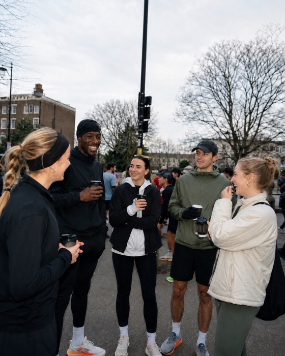 Friends catching up with drinks at a run club